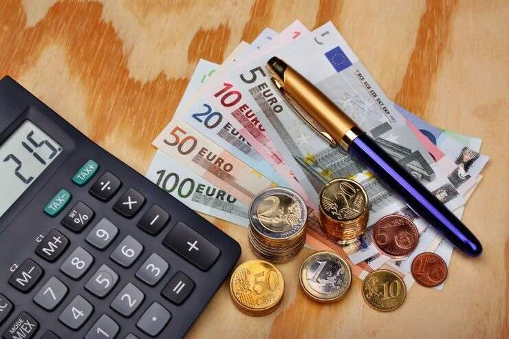 Calcolatrice, banconote euro, monete, penna