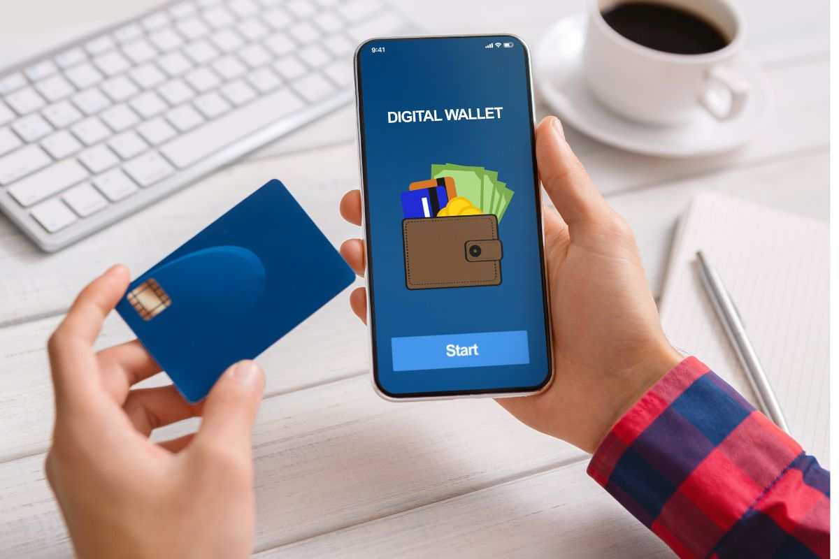 persona con in mano smartphone con app portafoglio digitale e carta bancomat