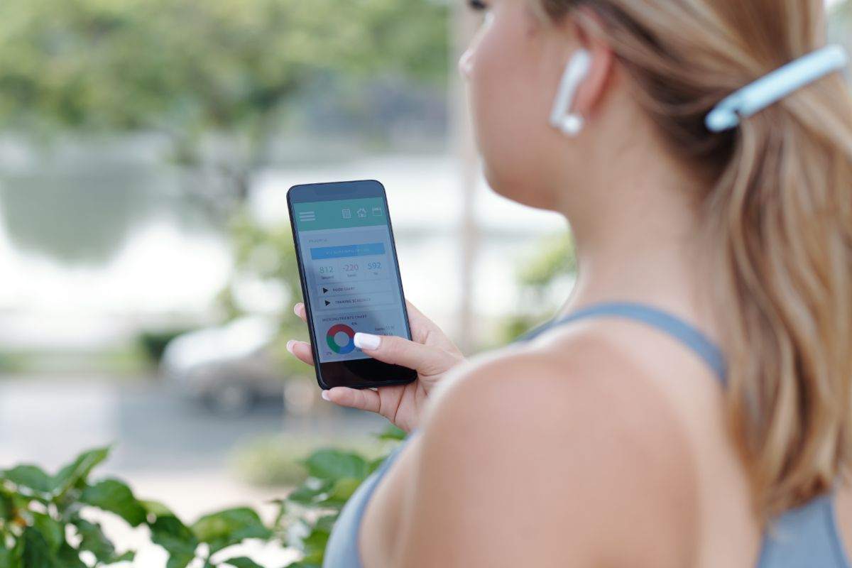 ragazza che si allena e usa lo smartphone