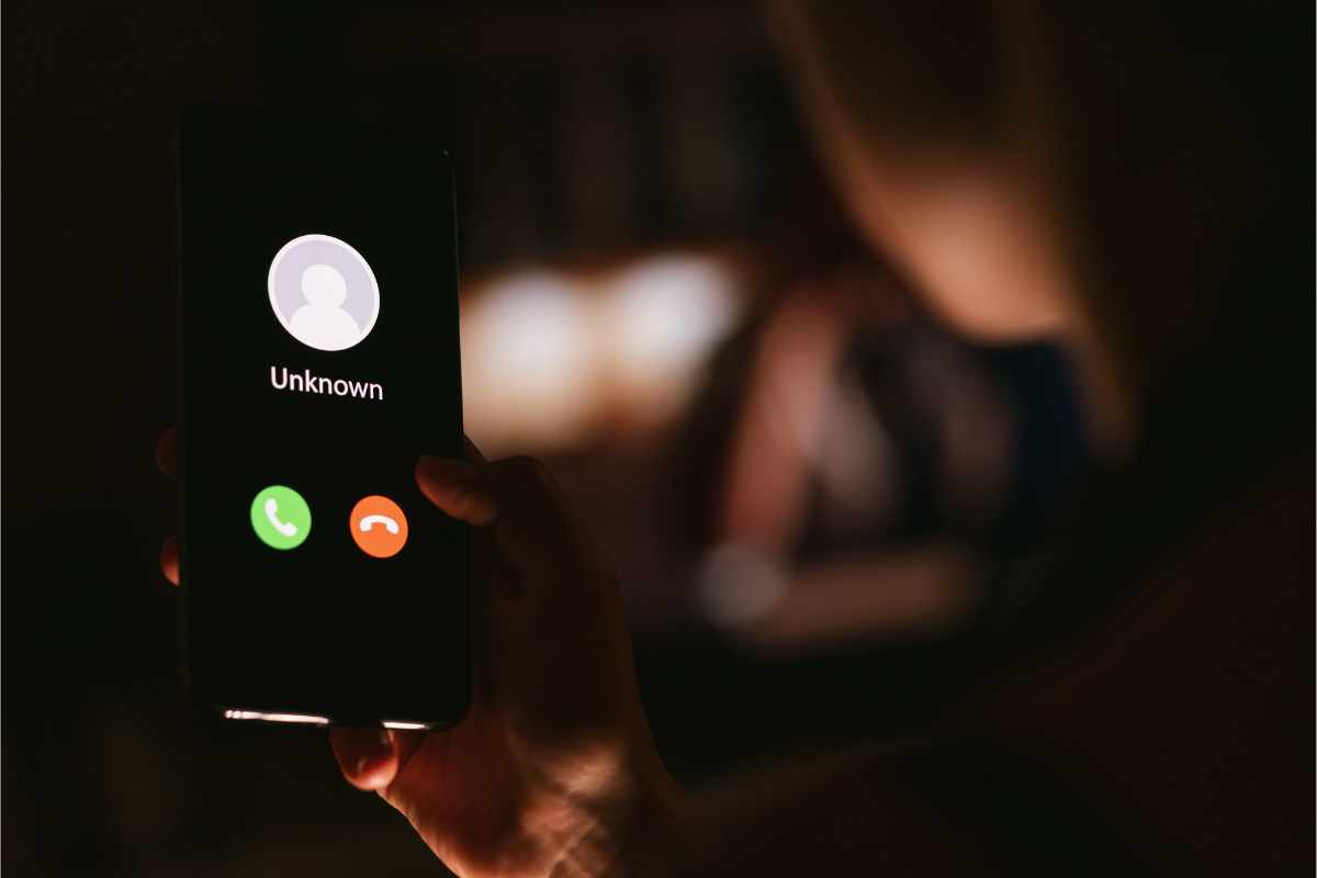 mano su smartphone e chiamata in arrivo