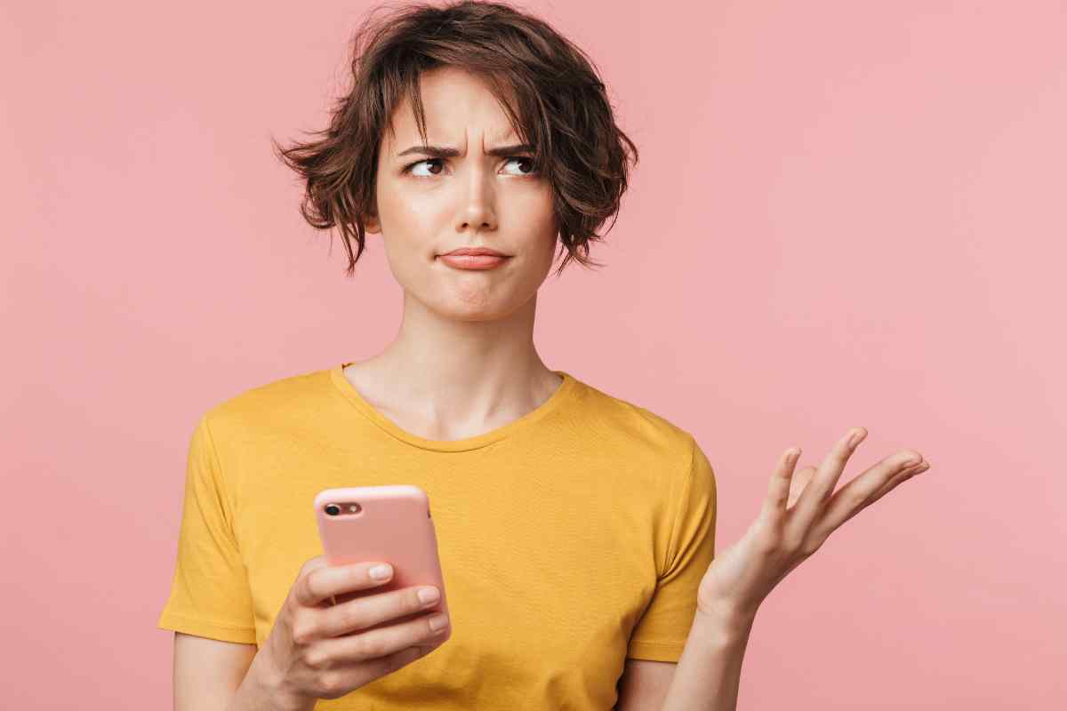donna dubbiosa con telefono