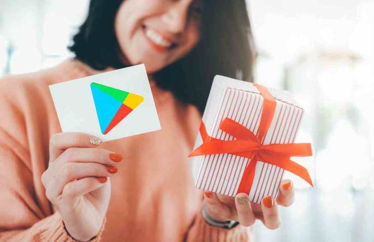 donna con pacchetto e gift card con logo play