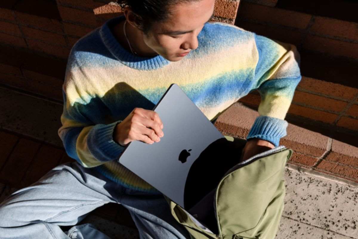 ragazzo ripone macbook nello zaino